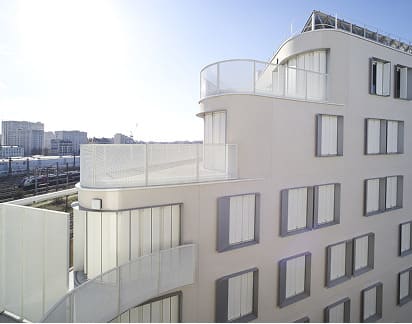 Barandillas metálicas blancas en balcones curvos de edificio residencial moderno